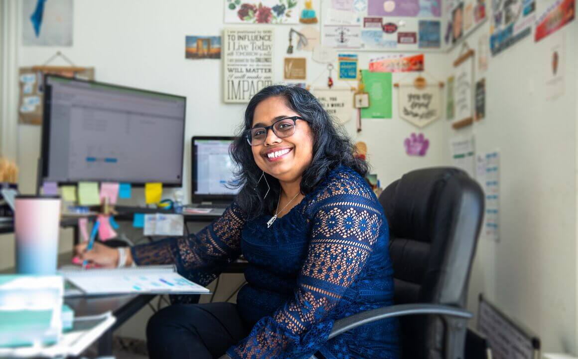 remote worker at home, smiling at camera