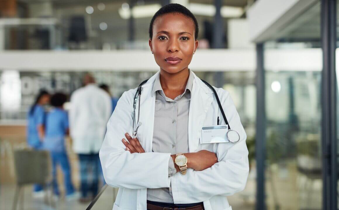 A female doctor faces the camera