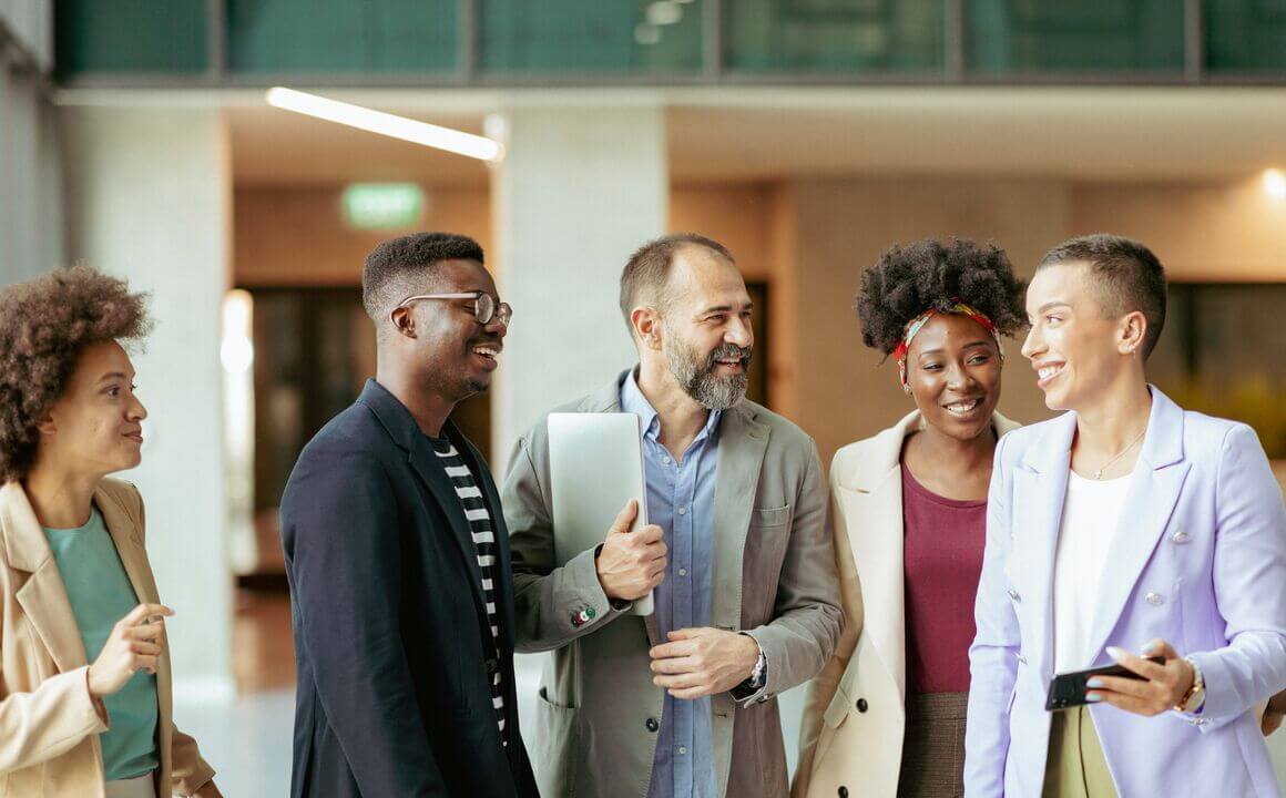 a group of employees chat in a foyer