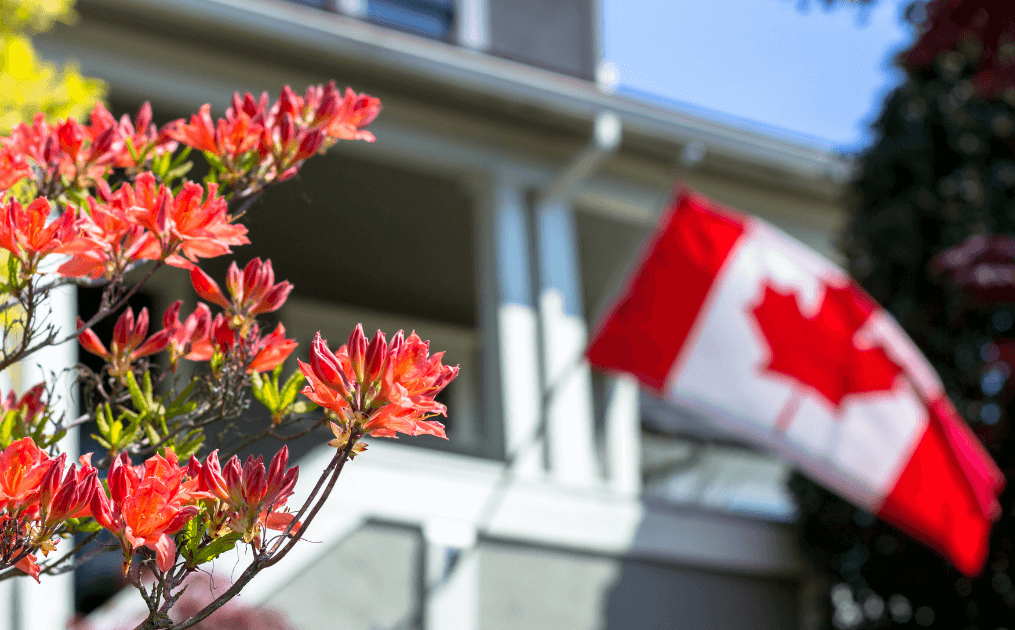 A Canadian home with flowers in the foreground