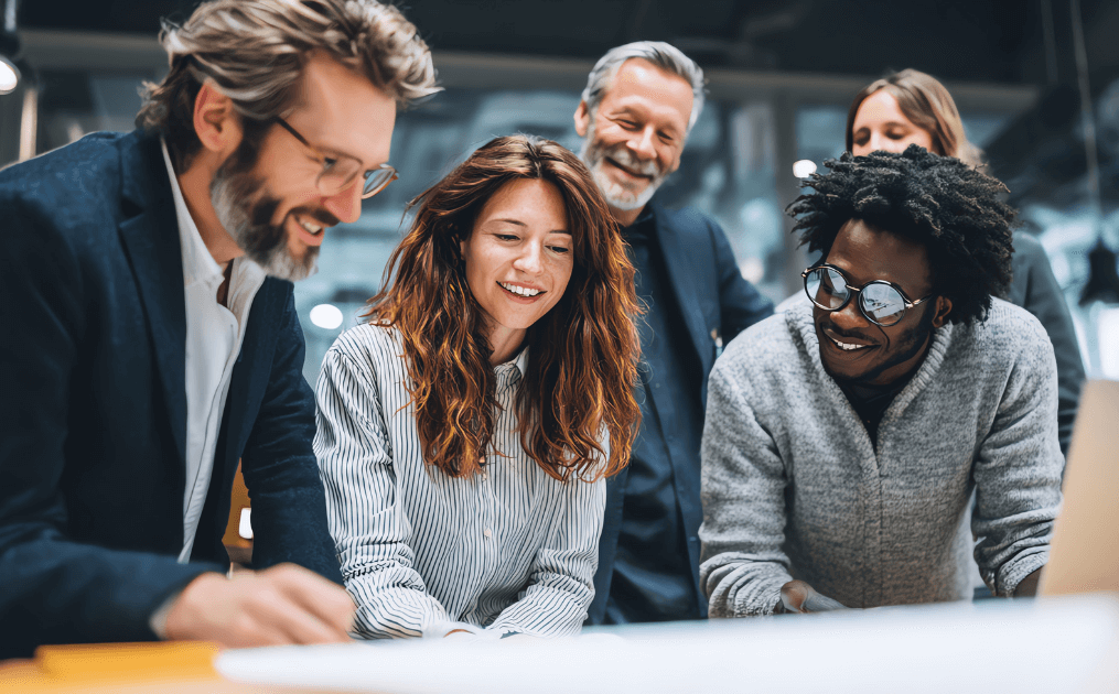 A dynamic group of employees collaborates around a table