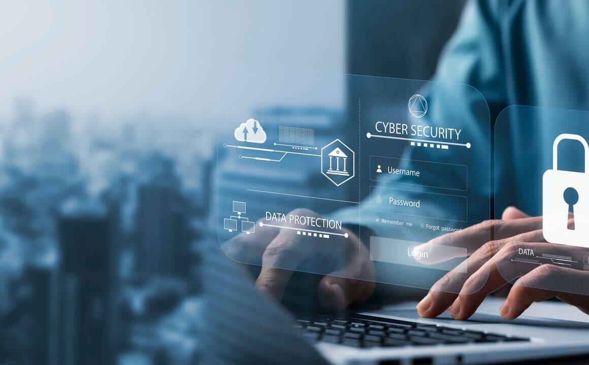 A person works on a computer while security icons hover