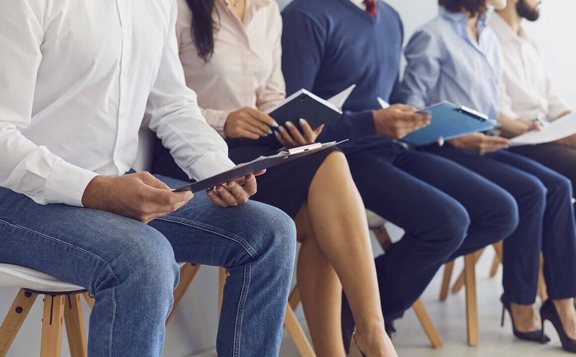 group of employees sitting down looking at printed material