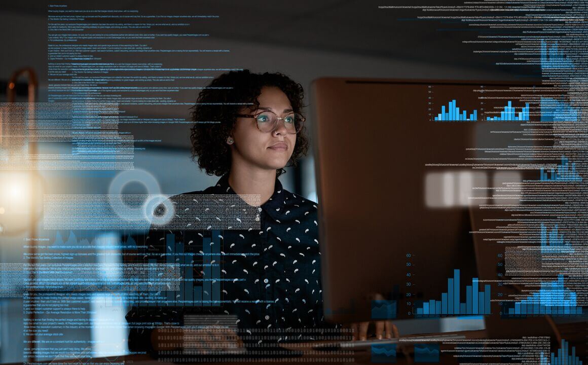 woman reviews charts and graphs on a modern digital display